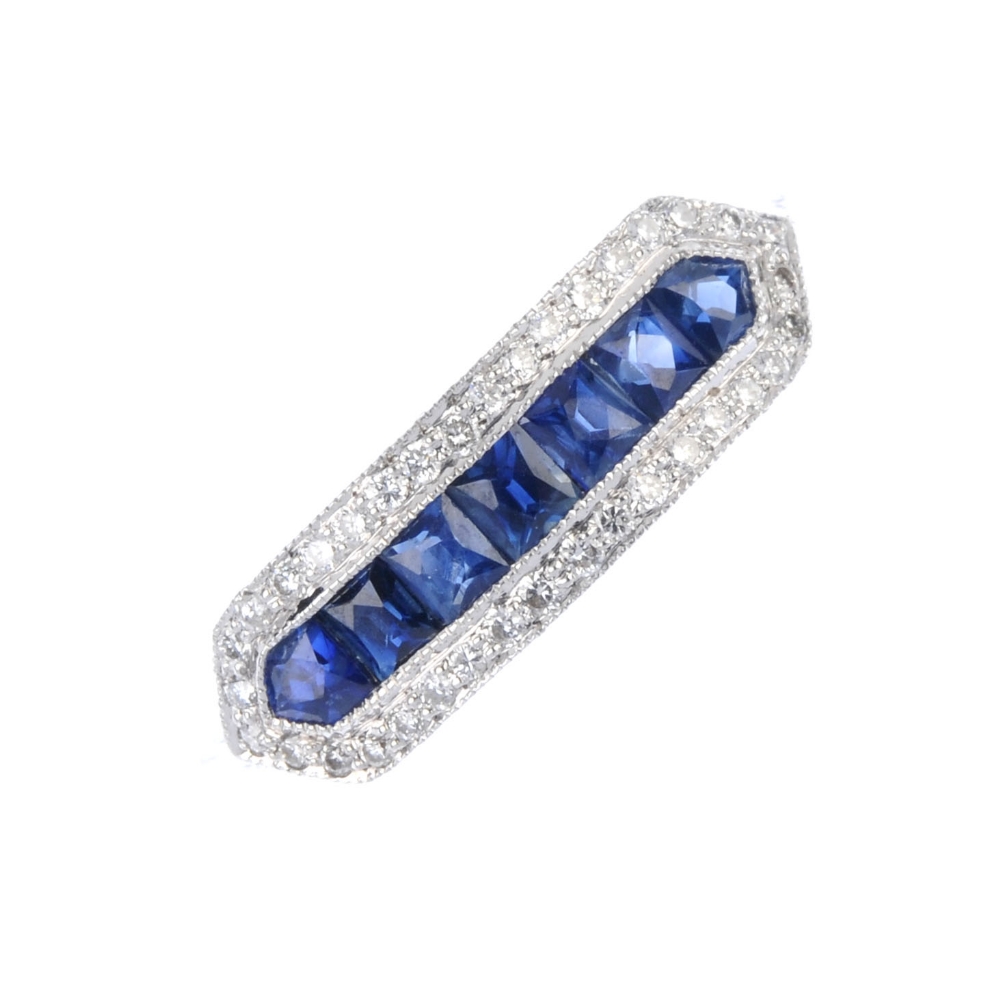 A sapphire and diamond dress ring. The calibre-cut sapphire line, within a brilliant-cut diamond