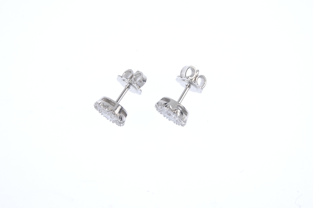 THEO FENNELL - a pair of diamond cluster ear studs. The brilliant-cut diamond within a similarly-cut - Image 2 of 2