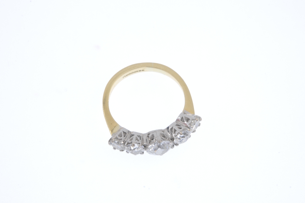 An 18ct gold diamond five-stone ring. The graduated old-cut diamond line, to the plain band. - Image 2 of 4