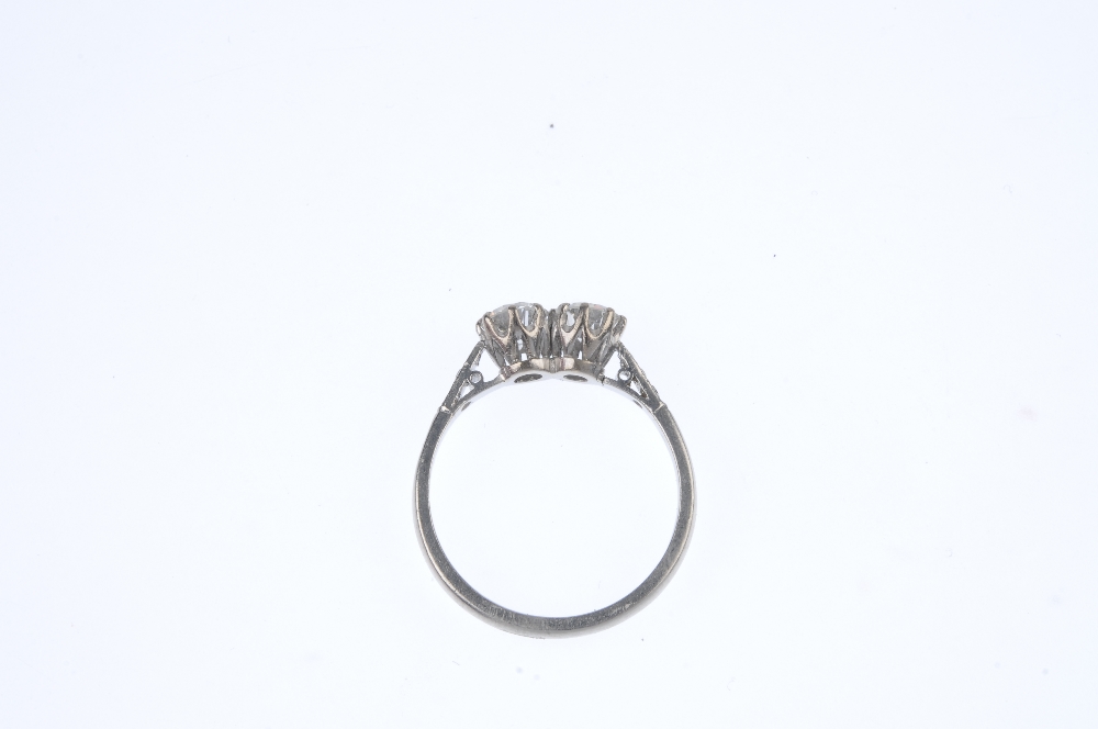 A diamond two-stone ring. The circular-cut diamond duo, with single-cut diamond line sides, to the - Image 3 of 3
