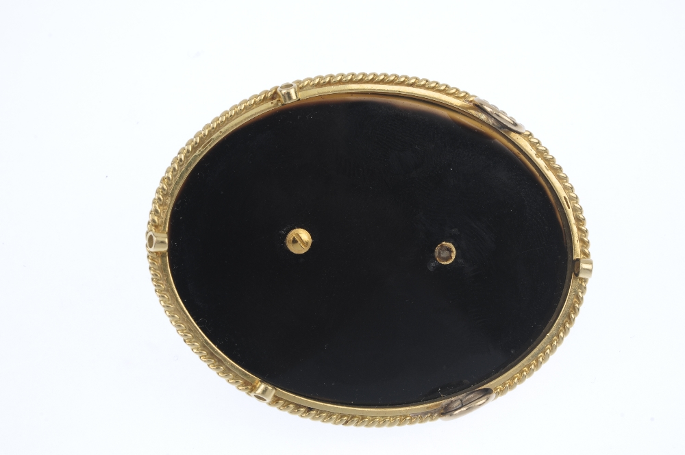 A 1970s 18ct gold and hardstone novelty panel. The oval-shape onyx base, with 18ct gold rope-twist - Image 2 of 2