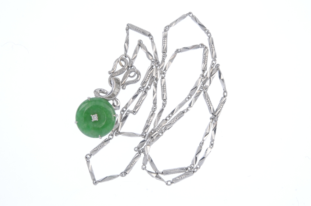 A jade and diamond pendant. The jadeite disc with brilliant-cut diamond highlight, suspended from - Image 3 of 3