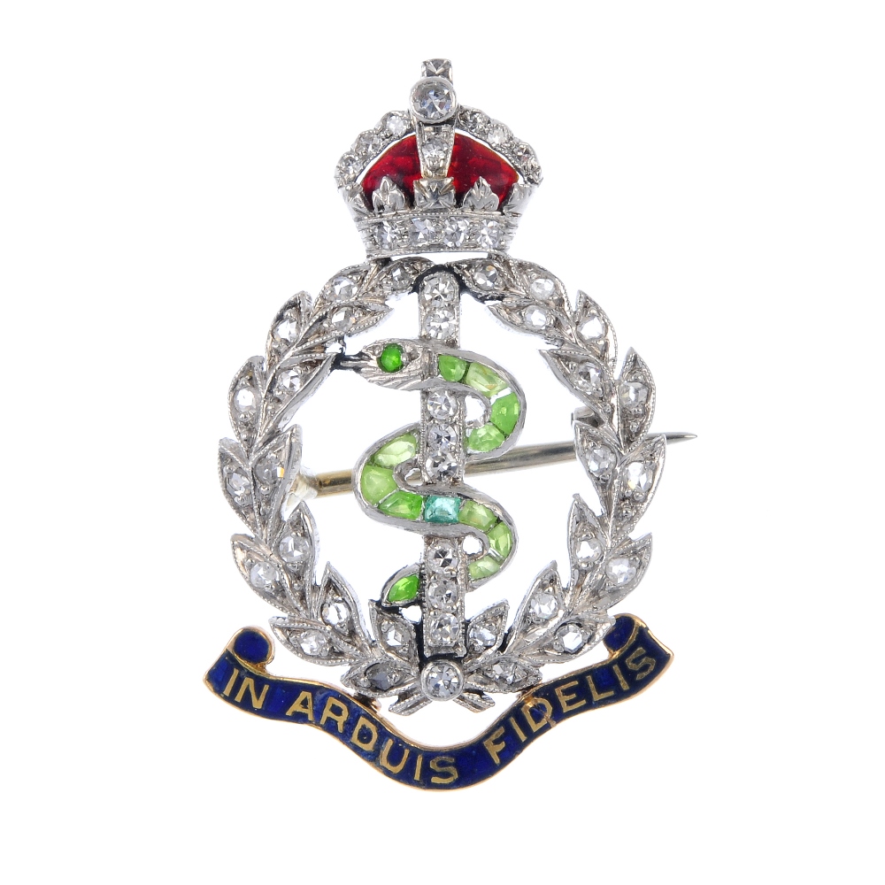 An early 20th century diamond, gem-set and enamel Royal Army Medical Corps brooch. The green gem and