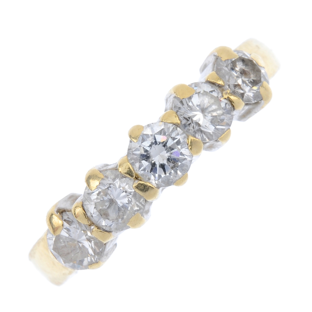 An 18ct gold diamond five-stone ring. The brilliant-cut diamond line, to the tapered band. Total