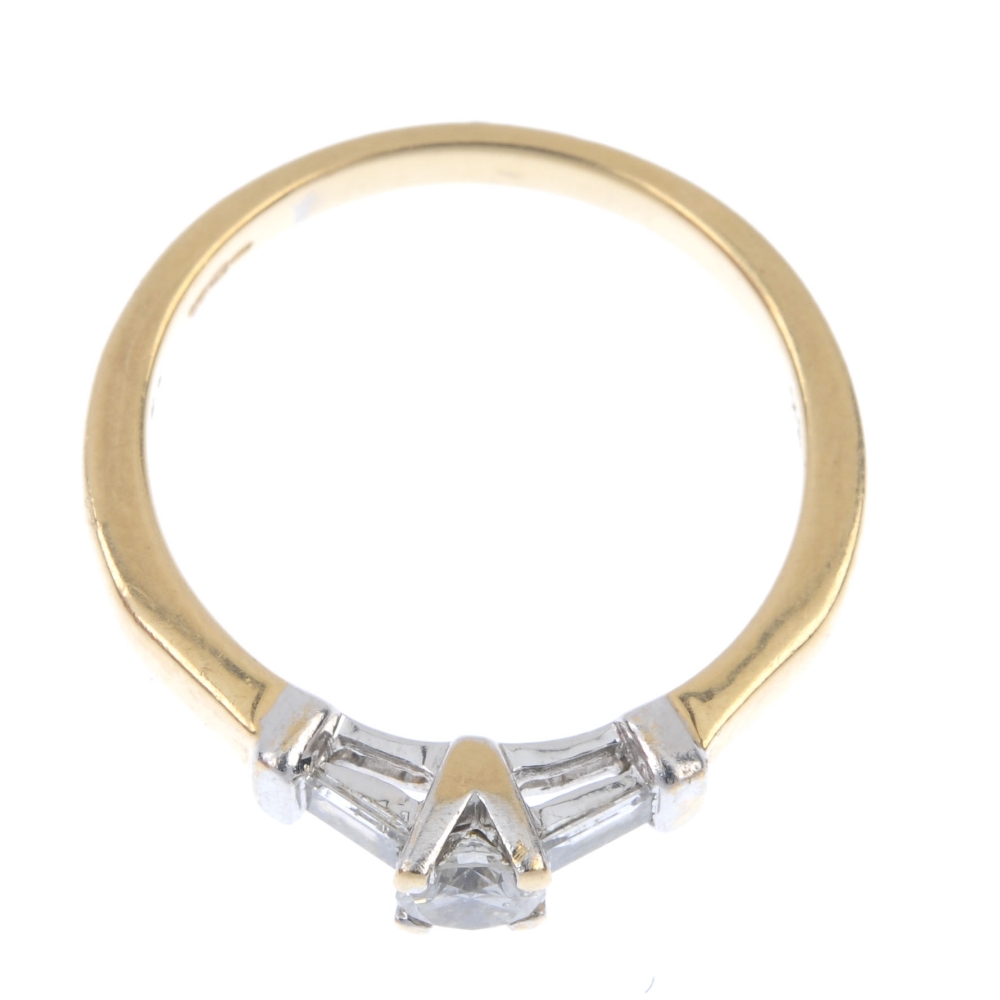 An 18ct gold diamond ring. Of bi-colour design, the brilliant-cut diamond, with baguette-cut diamond - Image 2 of 4