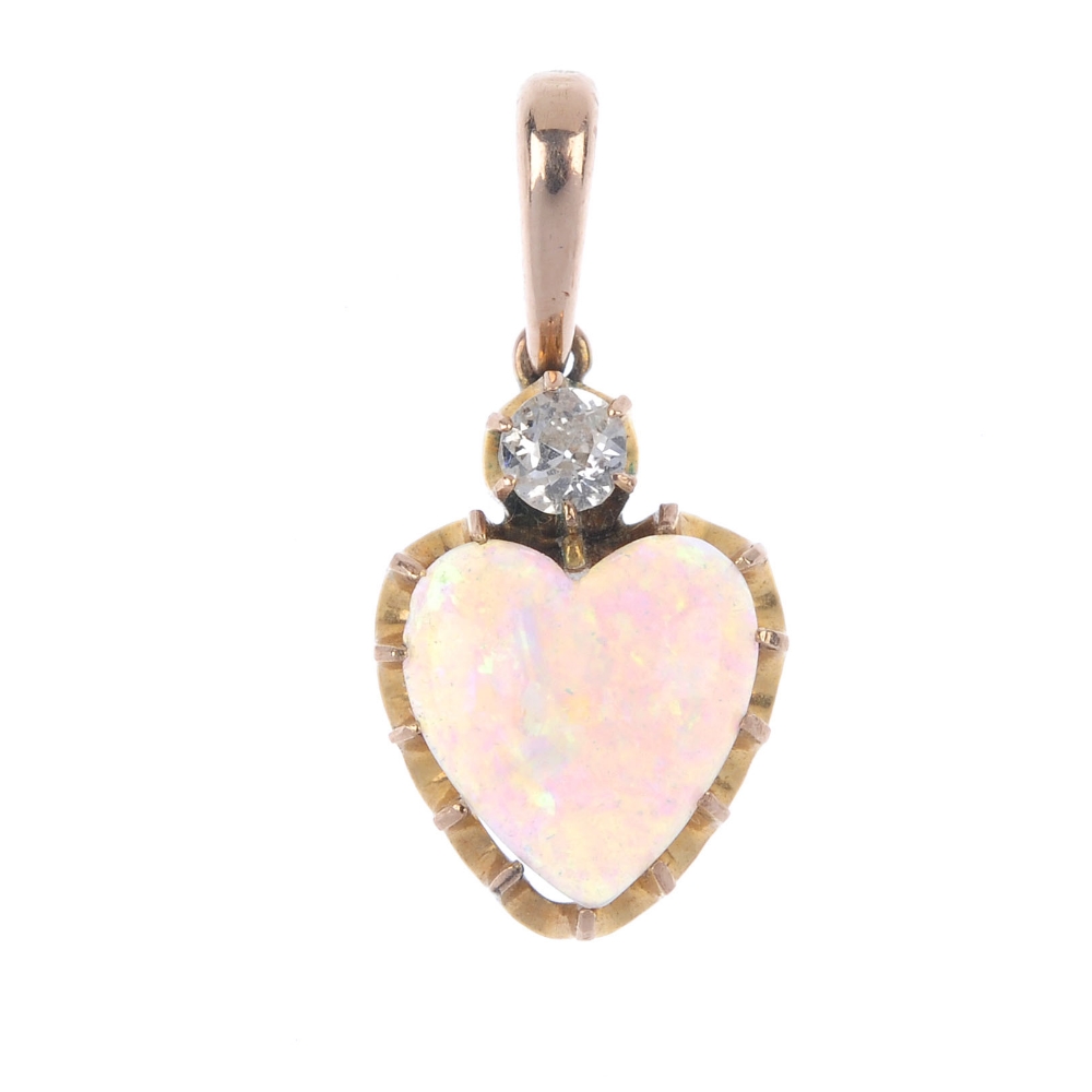 A mid 20th century opal and diamond pendant. The old-cut diamond, set atop a heart-shape opal