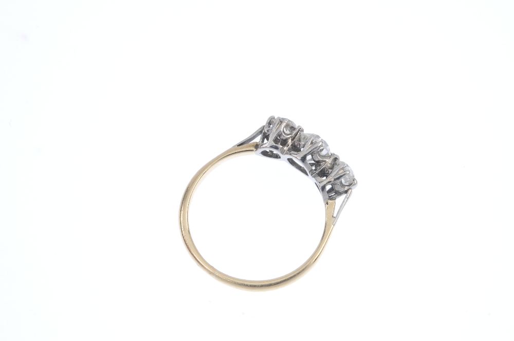 A diamond three-stone ring. The old-cut diamond, with similarly-cut diamond sides, to the plain - Image 4 of 4