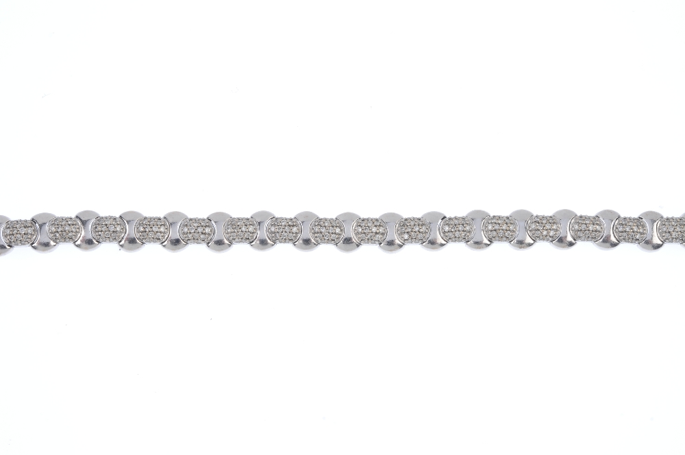 An 18ct gold diamond bracelet. Designed as a series of pave-set diamond links, with curved-link