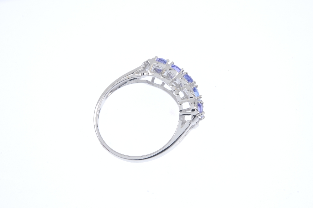 An 18ct gold tanzanite and diamond ring. The oval-shape tanzanite line, to the single-cut diamond - Image 4 of 4