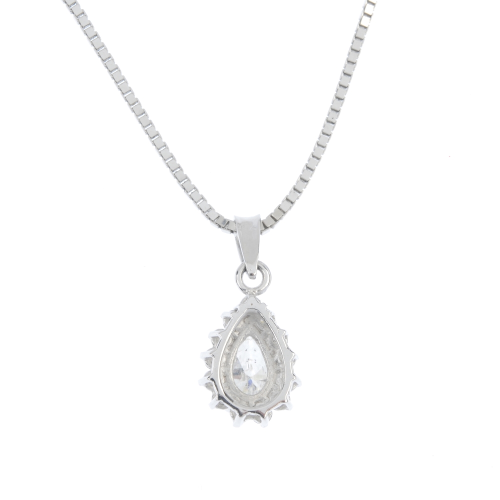 A diamond cluster pendant. The pear-shape diamond, within a brilliant-cut diamond surround, - Image 2 of 3