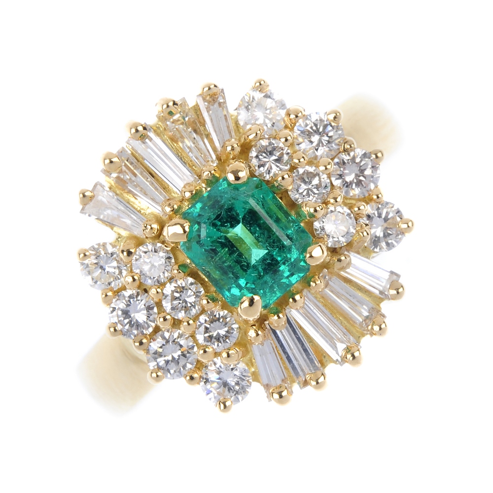 An emerald and diamond cluster ring. The rectangular-shape emerald, within a baguette and