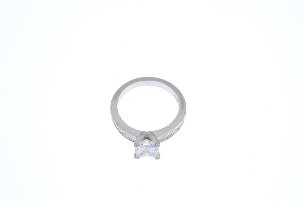 An 18ct gold diamond single-stone ring. The square-shape diamond, between similarly-cut diamond - Image 2 of 4