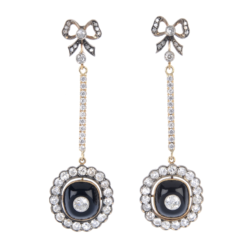 A pair of diamond and onyx ear pendants. Each designed as a cushion-shape onyx cabochon and old-