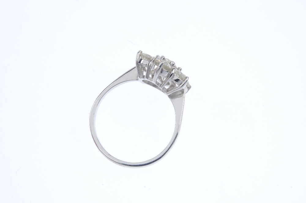 A diamond cluster ring. The brilliant-cut diamond, within a similarly-cut diamond surround, to the - Image 4 of 4