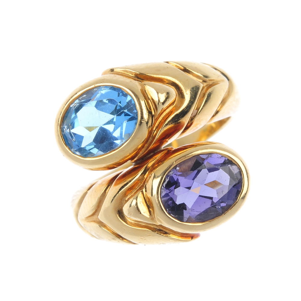 BULGARI - a gem-set crossover ring. Of asymmetric design, the grooved sides, with oval-shape blue