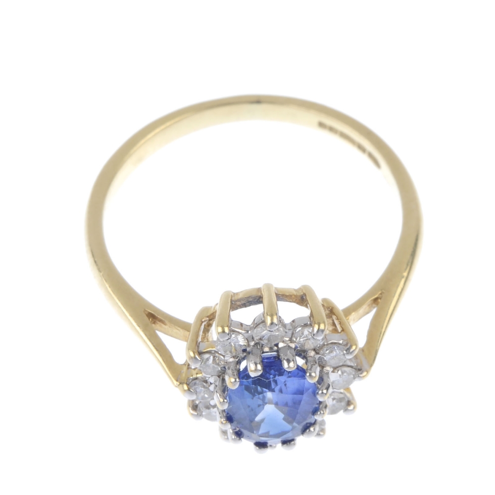 An 18ct gold sapphire and diamond cluster ring. The oval-shape sapphire, within a brilliant-cut - Image 2 of 4