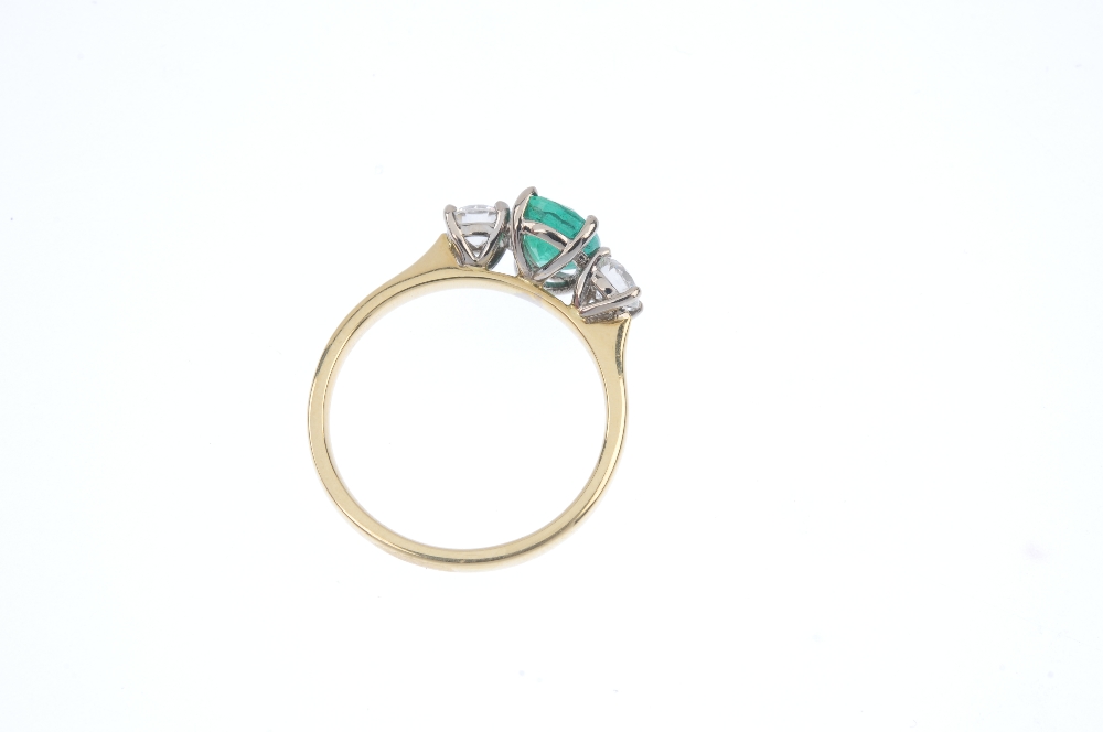 * An 18ct gold emerald and diamond three-stone ring. The oval-shape emerald, to the brilliant-cut - Image 4 of 4