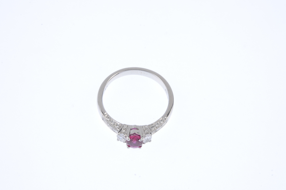 * An 18ct gold ruby and diamond dress ring. The oval-shape ruby and diamond sides, to the baguette- - Image 2 of 4