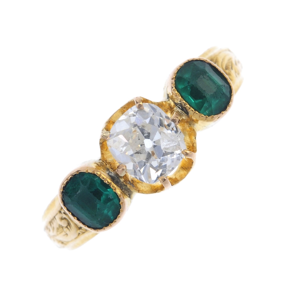 A late 19th century 18ct gold diamond and paste ring. The old-cut diamond, with green paste sides,