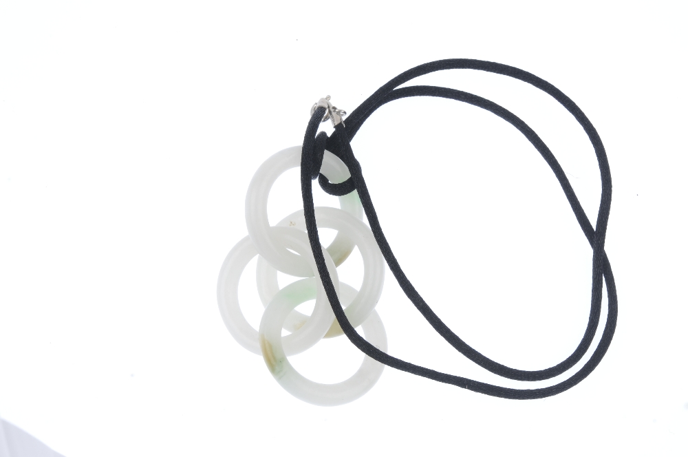 A jade pendant. Designed as a series of four interlocking nephrite jade hoops, to the black fabric - Image 2 of 2