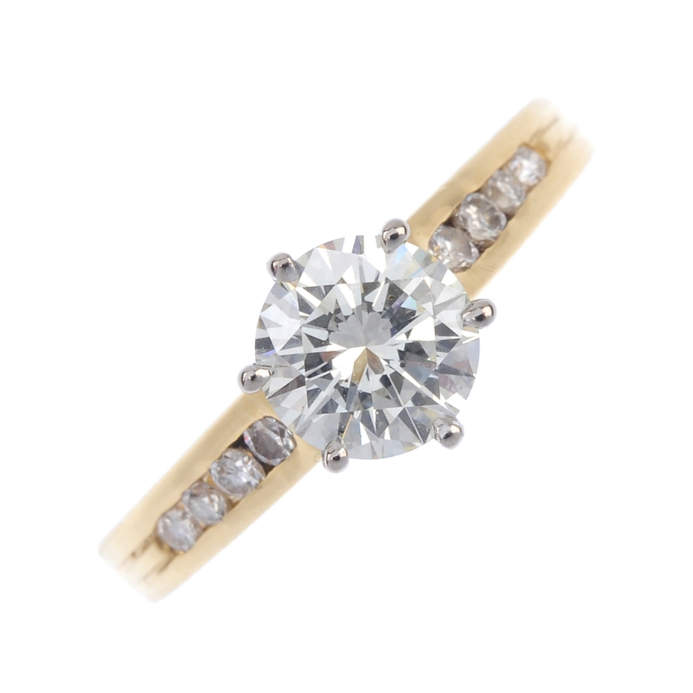 A diamond single-stone ring. The brilliant-cut diamond, raised to the graduated similarly-cut
