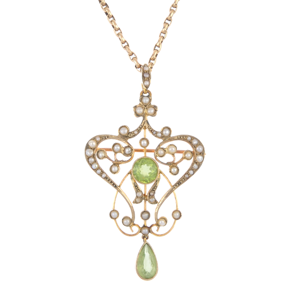 An early 20th century 15ct gold peridot and split pearl pendant. The circular-shape peridot,