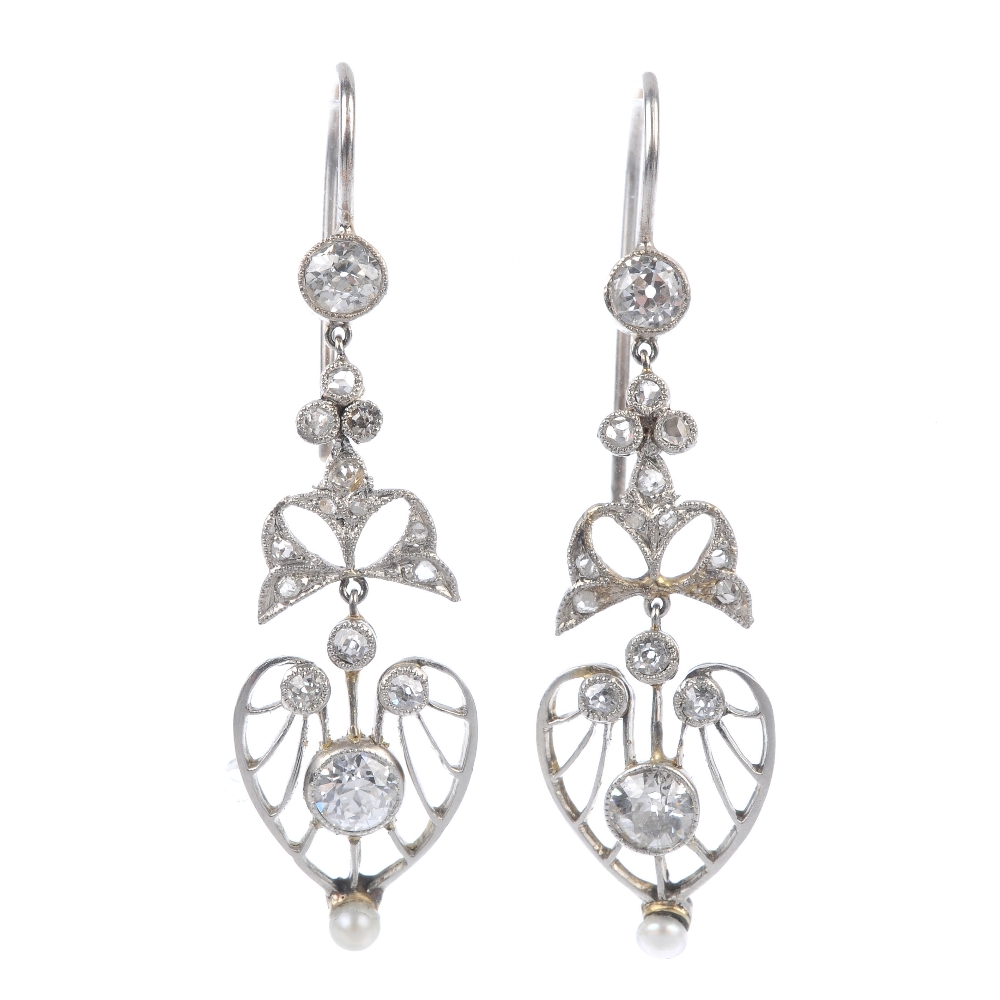 A pair of diamond and seed pearl ear pendants. Each designed as an old-cut diamond openwork panel,