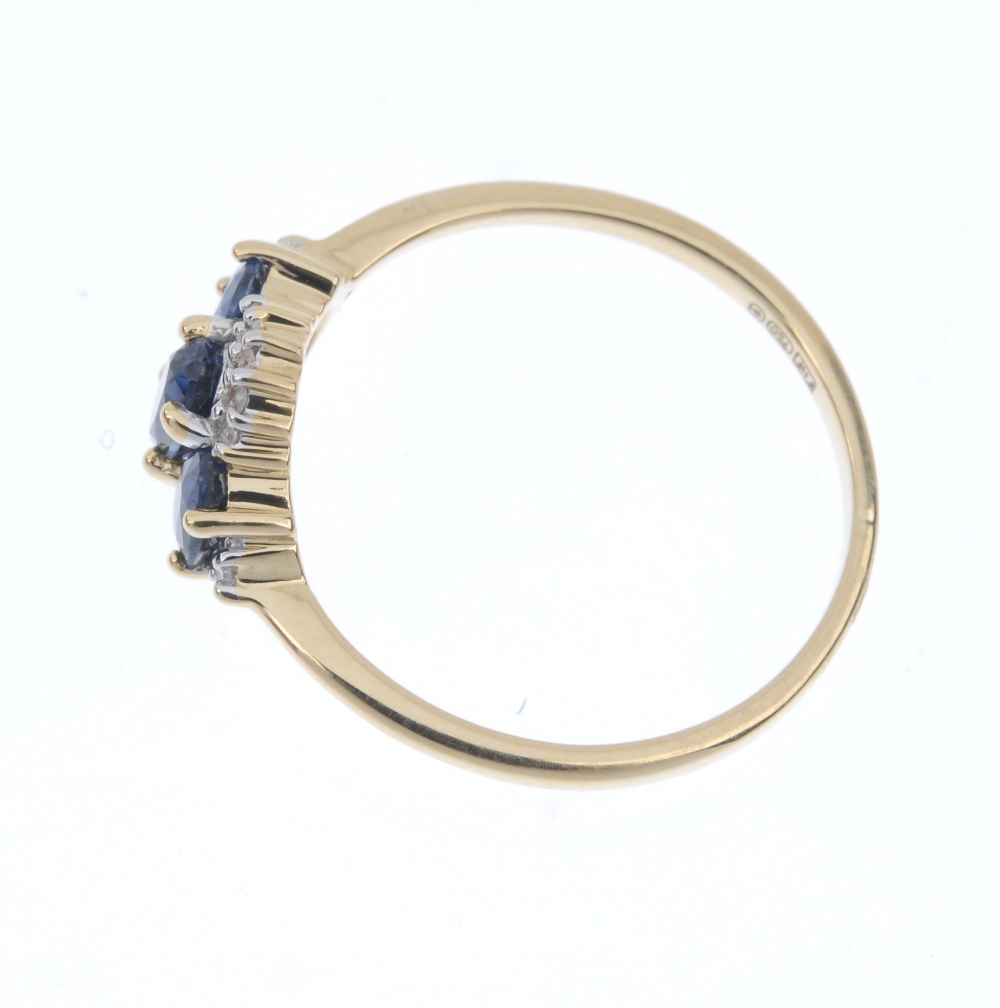 An 18ct gold sapphire and diamond three-stone ring. The slightly graduated oval-shape sapphire line, - Image 3 of 4