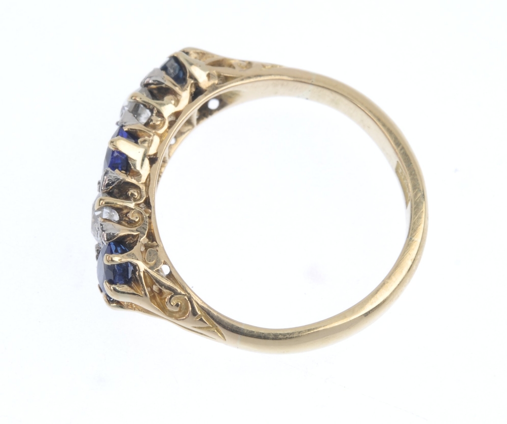 A sapphire and diamond ring. The graduated oval-shape sapphire line, with old-cut diamond spacers, - Image 3 of 4