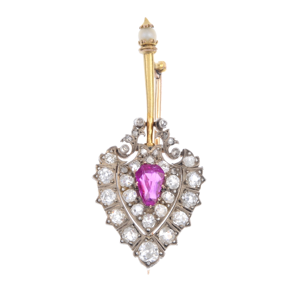 A Burmese ruby and diamond brooch. The pear-shape Burmese ruby, within an old and rose-cut diamond