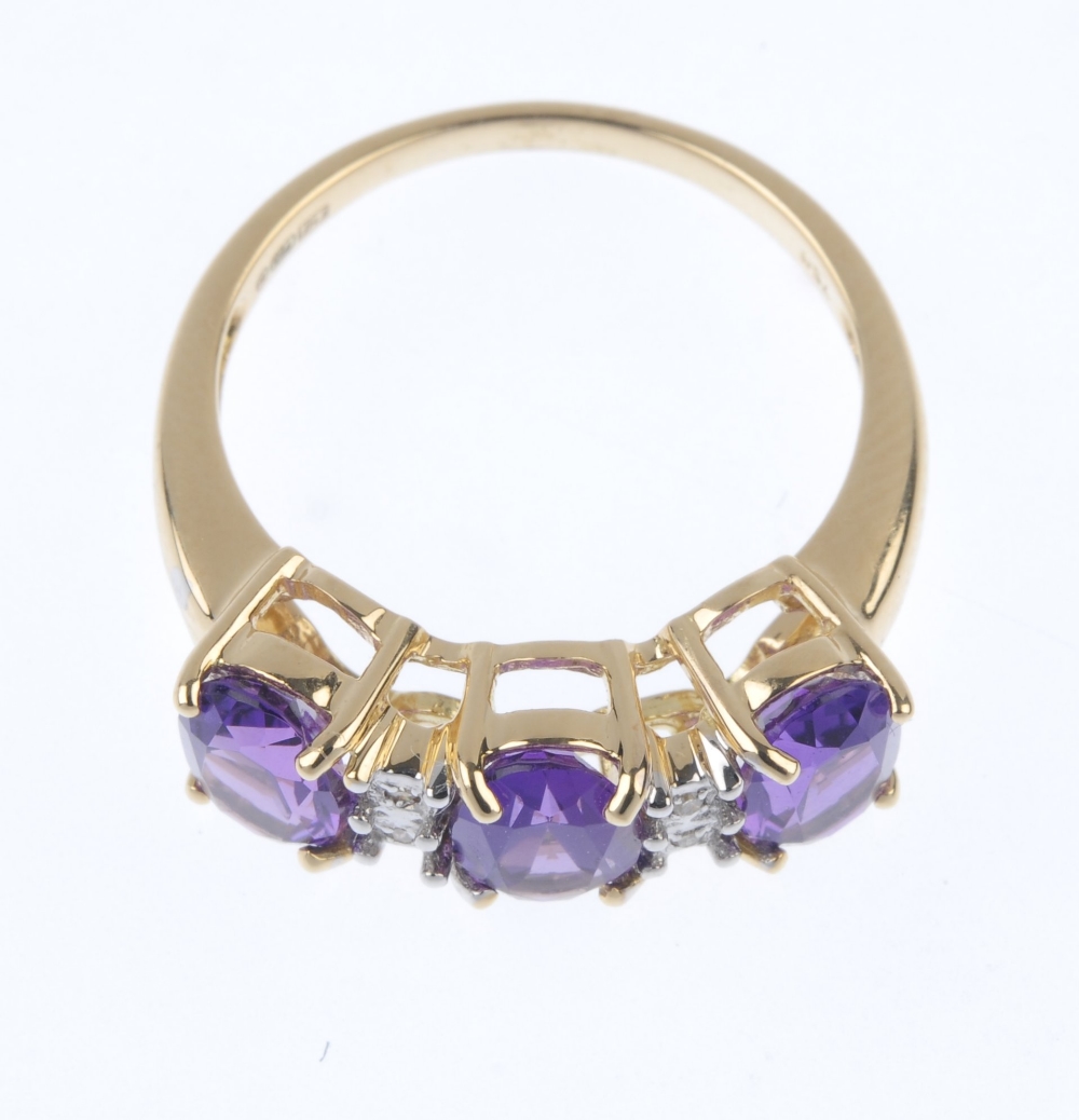 An 18ct gold amethyst and diamond ring. The oval-shape amethyst line, between single-cut diamond - Image 2 of 4