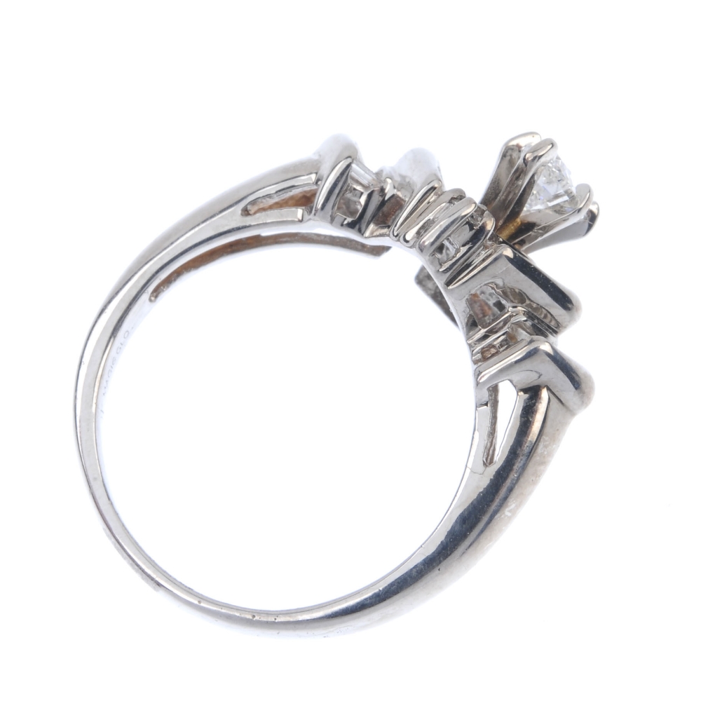 A diamond dress ring. The marquise-shape diamond, with tapered baguette-cut diamond chevron - Image 4 of 4