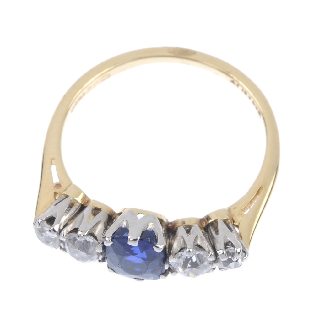 An 18ct gold sapphire and diamond five-stone ring. The oval-shape sapphire, with graduated old-cut - Image 2 of 4