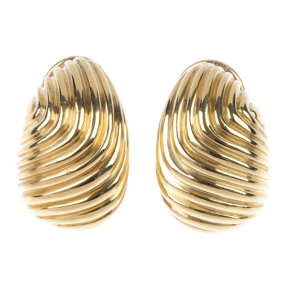 TIFFANY & CO. - a pair of 1970s earrings. Each designed as a grooved scrolling line panel. One