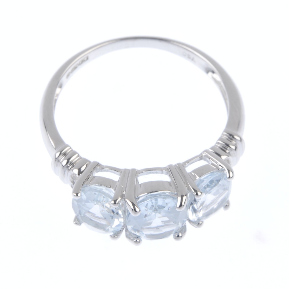 An 18ct gold aquamarine and diamond ring. The oval-shape aquamarine line, with single-cut diamond - Image 2 of 4