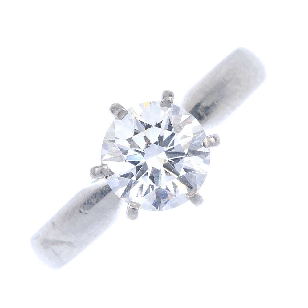 A platinum diamond single-stone ring. The brilliant-cut diamond, to the plain band. Estimated