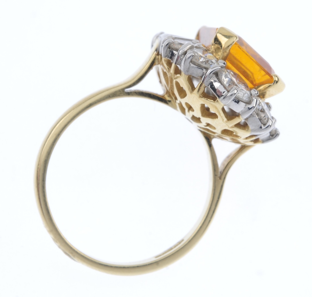 An 18ct gold sapphire and diamond cluster ring. The rectangular-shape orange sapphire, within a - Image 4 of 4