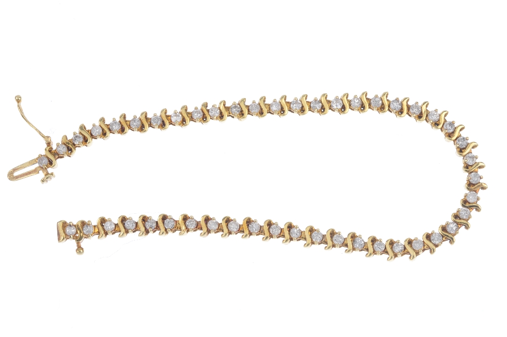A diamond line bracelet. Designed as a series of brilliant-cut diamonds, with scrolling bar spacers, - Image 3 of 3