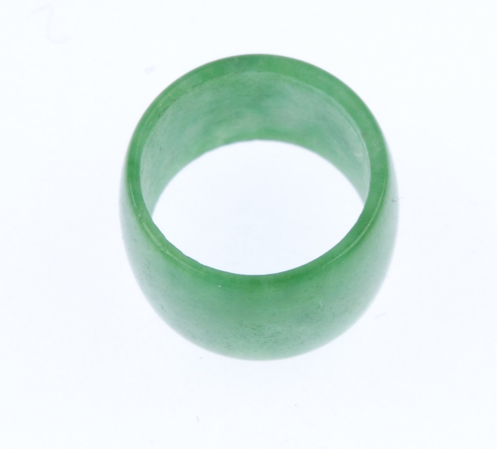 A jade bead. Designed as a jadeite polished cylindrical bead. Length 8.75mms. Weight 1.3gms. Jade - Image 2 of 2