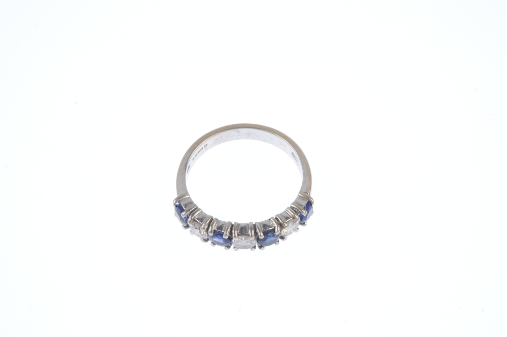 An 18ct gold sapphire and diamond band ring. The alternating brilliant-cut diamond and circular- - Image 2 of 4