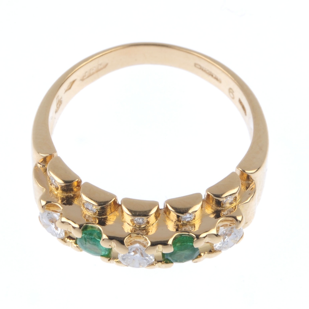 An 18ct gold emerald and diamond dress ring. The alternating brilliant-cut diamond and circular- - Image 2 of 4