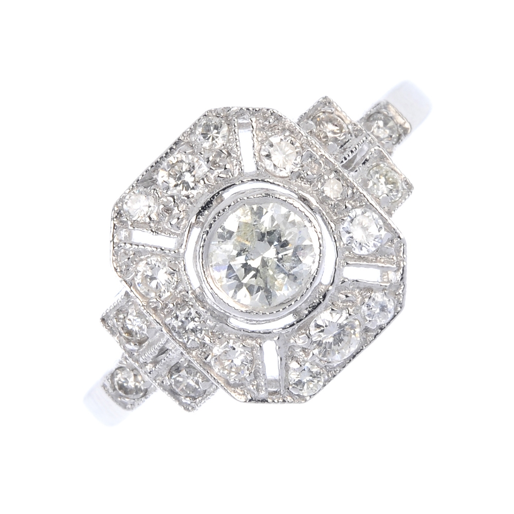 A diamond dress ring. The brilliant-cut diamond collet, to the similarly-cut diamond panel and