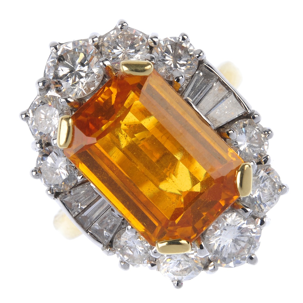An 18ct gold sapphire and diamond cluster ring. The rectangular-shape orange sapphire, within a