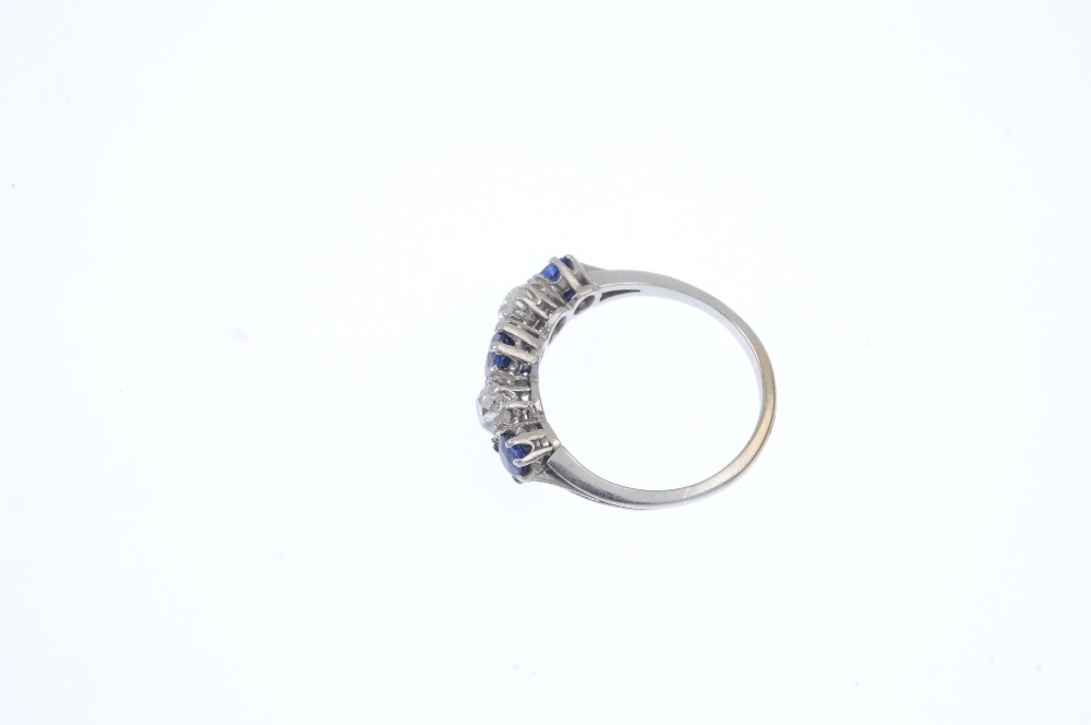 An early 20th century platinum and gold, sapphire and diamond ring. The alternating graduated oval- - Image 3 of 4