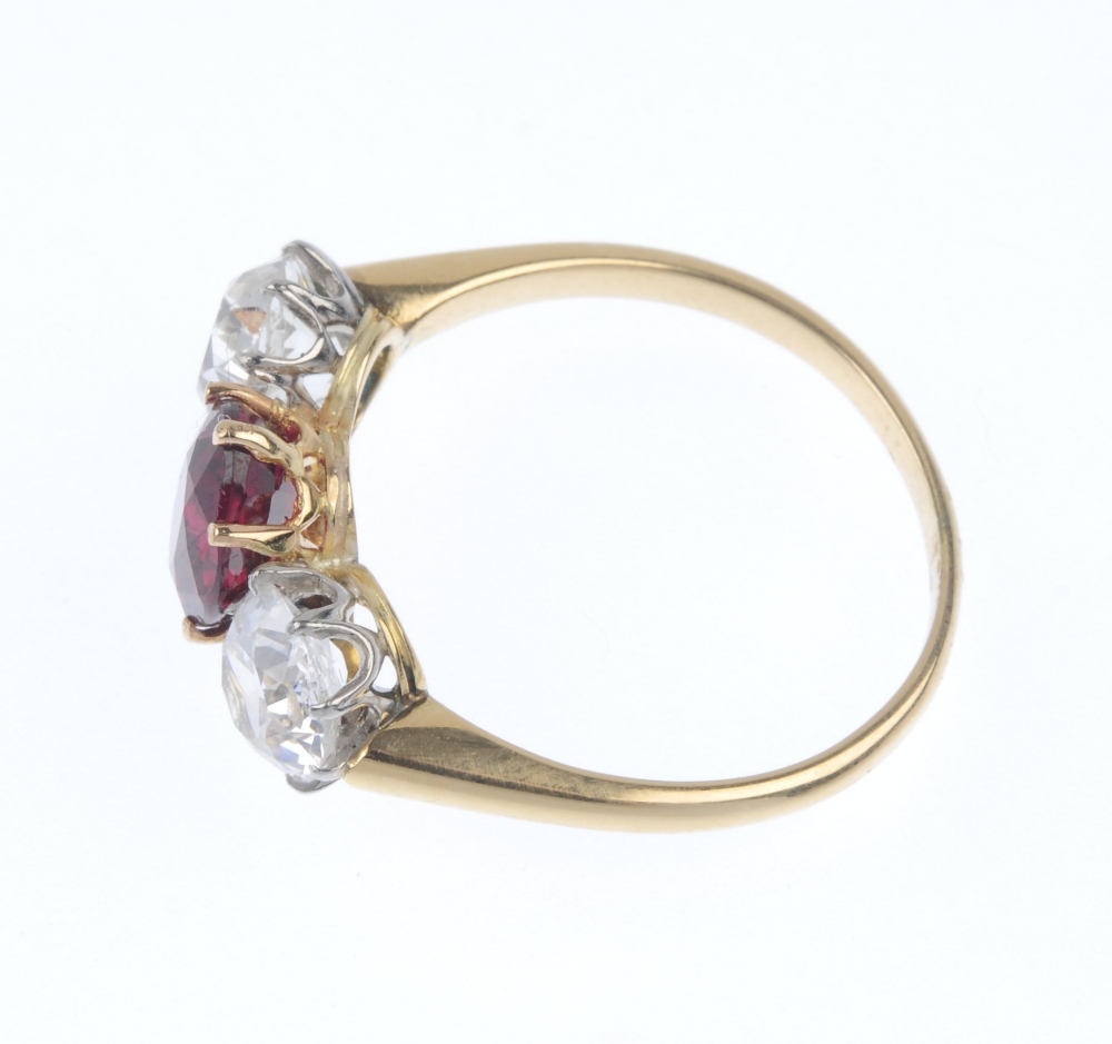 A diamond and ruby three-stone ring. The oval-shape ruby, with old-cut diamond sides, to the plain - Image 3 of 4