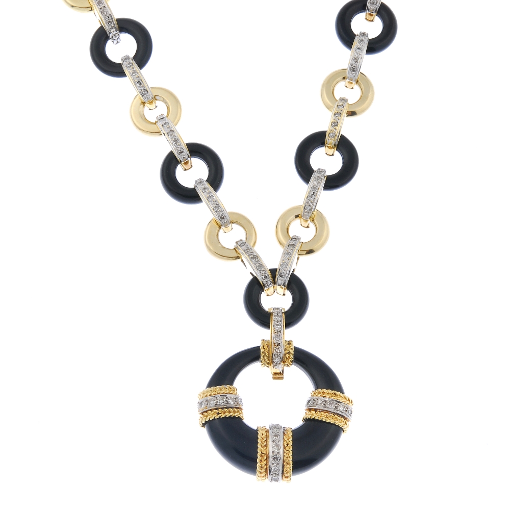 An onyx and diamond necklace. The tapered onyx hoop pendant, with overlaid single-cut diamond line