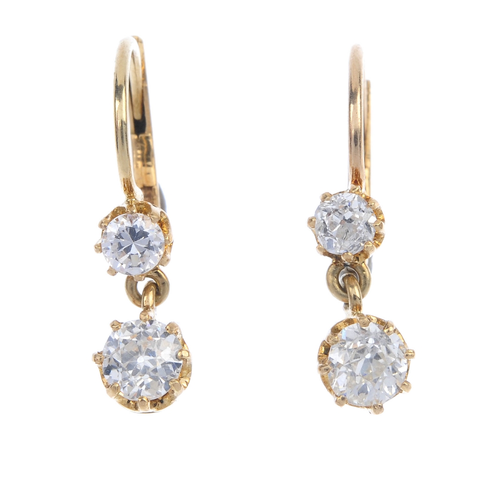 A pair of diamond ear pendants. Each designed as an old-cut diamond, suspended from a similarly-