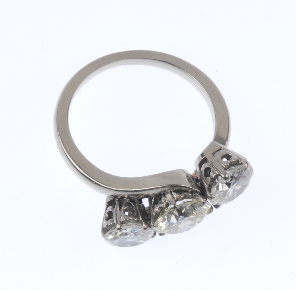 A diamond three-stone crossover ring. The graduated circular-shape diamond line, to the asymmetric - Image 3 of 3