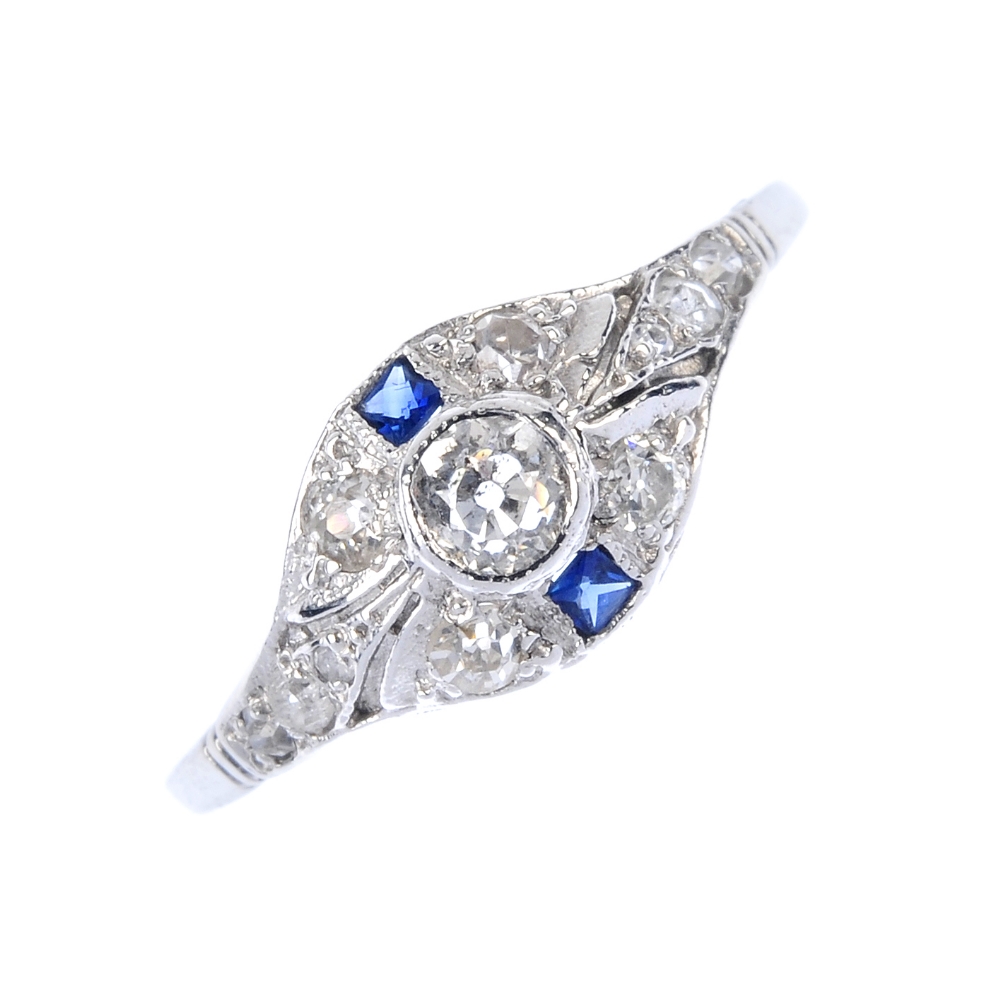 A diamond and sapphire dress ring. The old-cut diamond collet, within a similarly-set diamond and