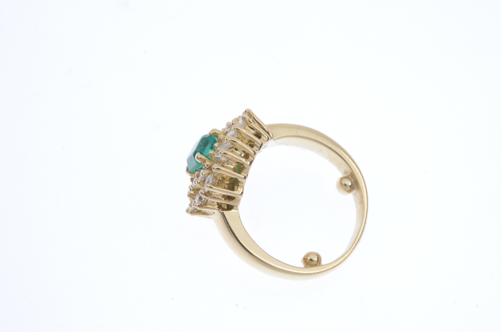 An emerald and diamond cluster ring. The rectangular-shape emerald, within a baguette and - Image 3 of 4